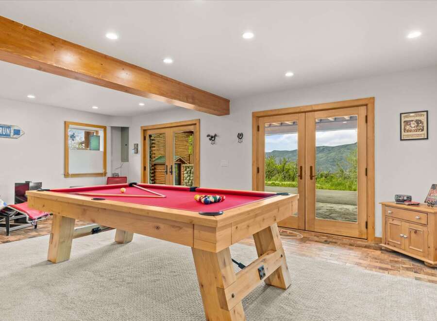 Enjoy endless entertainment in this spacious game room, featuring a professional billiard table perfect for friendly competitions.