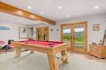 Enjoy endless entertainment in this spacious game room, featuring a professional billiard table perfect for friendly competitions.