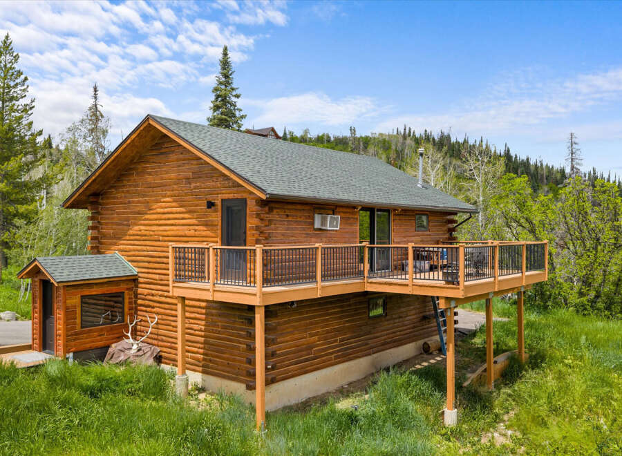 Experience rustic charm in this beautiful log cabin, nestled amidst lush greenery and mature trees.