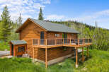Experience rustic charm in this beautiful log cabin, nestled amidst lush greenery and mature trees.