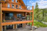Experience luxury mountain living in this stunning log home, featuring multiple levels of expansive decks perfect for entertaining or enjoying the serene natural surroundings.