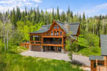 Experience luxury mountain living in this stunning log home, nestled amidst a lush forest.