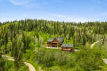 Nestled amidst a lush forest, this stunning property features two beautiful log homes, perfect for a family retreat or a rental income opportunity.