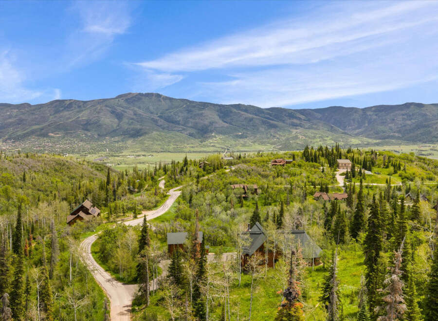 Nestled amidst rolling green hills and mature trees, this property offers a serene mountain retreat.
