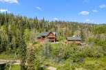 Nestled amidst a lush forest, this stunning mountain lodge offers breathtaking views and serene privacy.