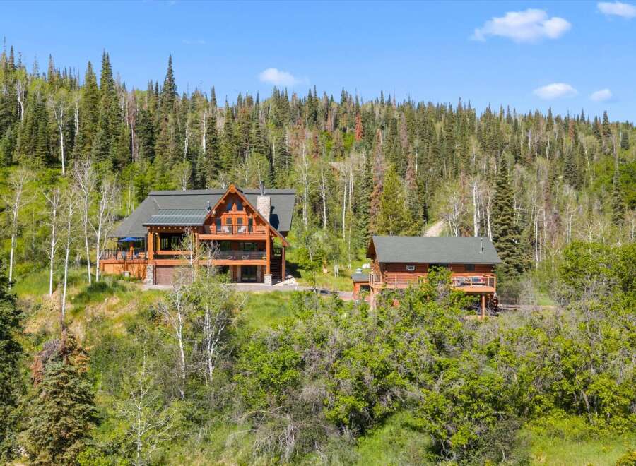 Nestled amidst a lush forest, this stunning log home offers a serene mountain retreat.