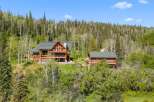 Nestled amidst a lush forest, this stunning log home offers a serene mountain retreat.