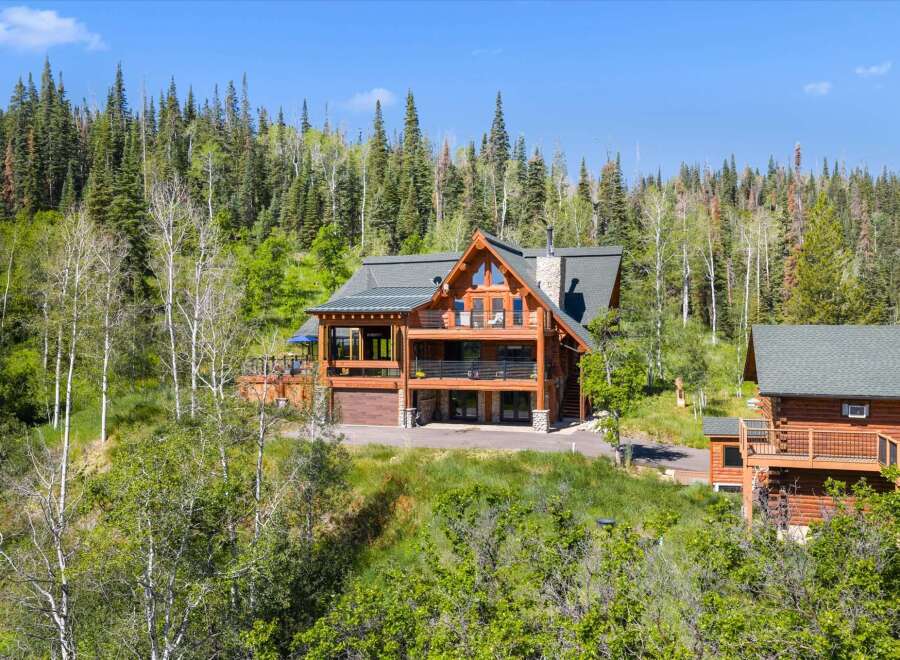 Experience luxury mountain living in this stunning log home nestled amidst a serene forest.