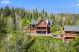 Experience luxury mountain living in this stunning log home nestled amidst a serene forest.