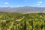 Nestled amidst lush greenery and towering pine trees, this stunning property offers breathtaking panoramic views of the majestic mountains.