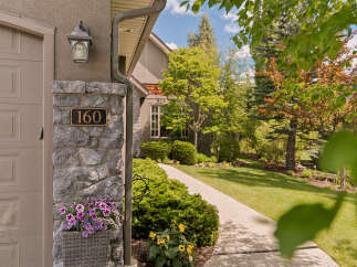 Welcome to this charming property, beautifully situated with a well-maintained lawn and lush landscaping.