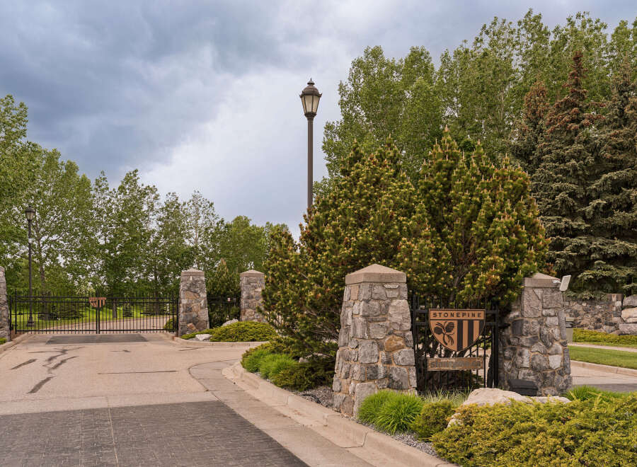 Discover the exclusive Stonepine community, offering a prestigious entrance with elegant stone pillars and a secure gated access.