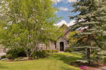 Discover this charming home featuring a beautiful stone facade and an arched entryway, perfect for welcoming guests.