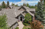 Discover this stunning home featuring a distinctive stone-accented arched entryway, perfect for welcoming guests.