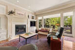 This inviting living room features a grand fireplace with intricate molding, perfect for cozy evenings.