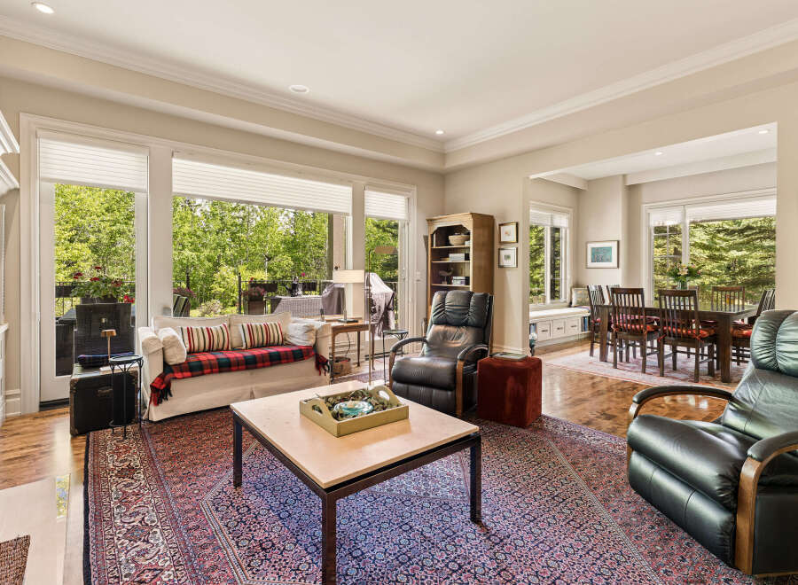 Experience elegant living in this spacious home, featuring a comfortable living area with a plush sofa and a cozy recliner, perfect for relaxation.