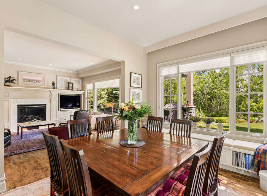 This elegant dining room features a large wooden table with seating for eight, perfect for hosting gatherings.