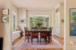 This elegant dining room features a large wooden table with six chairs, perfect for family gatherings.