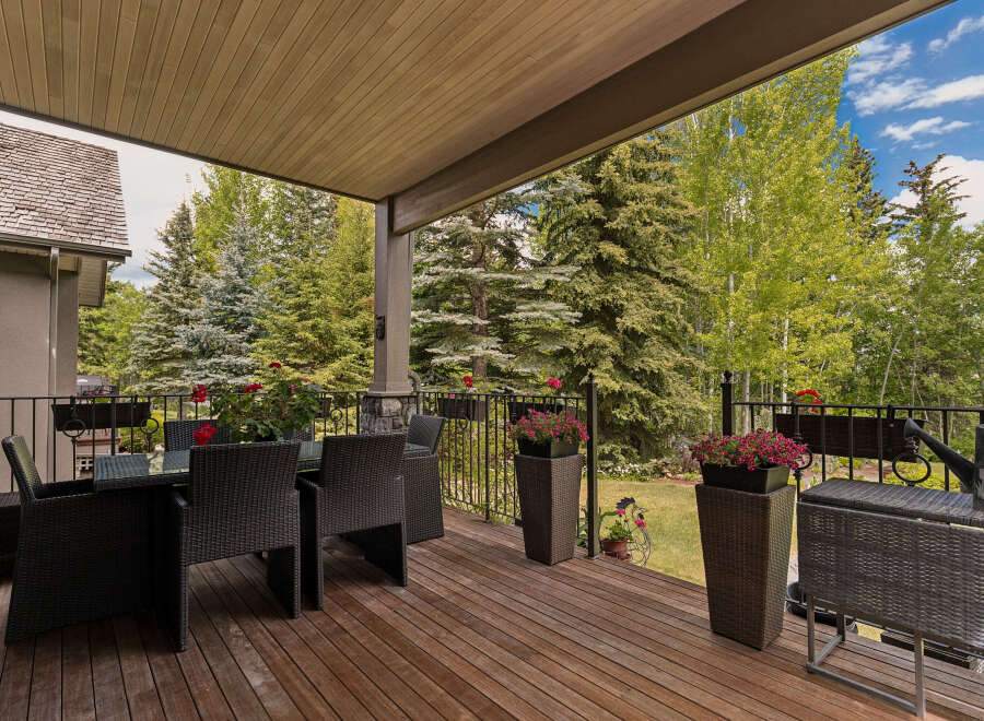 Enjoy outdoor living on this spacious covered deck, perfect for al fresco dining or relaxing amidst nature.