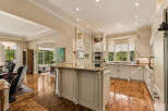 This spacious kitchen boasts elegant cream cabinetry, granite countertops, and a large island perfect for entertaining.