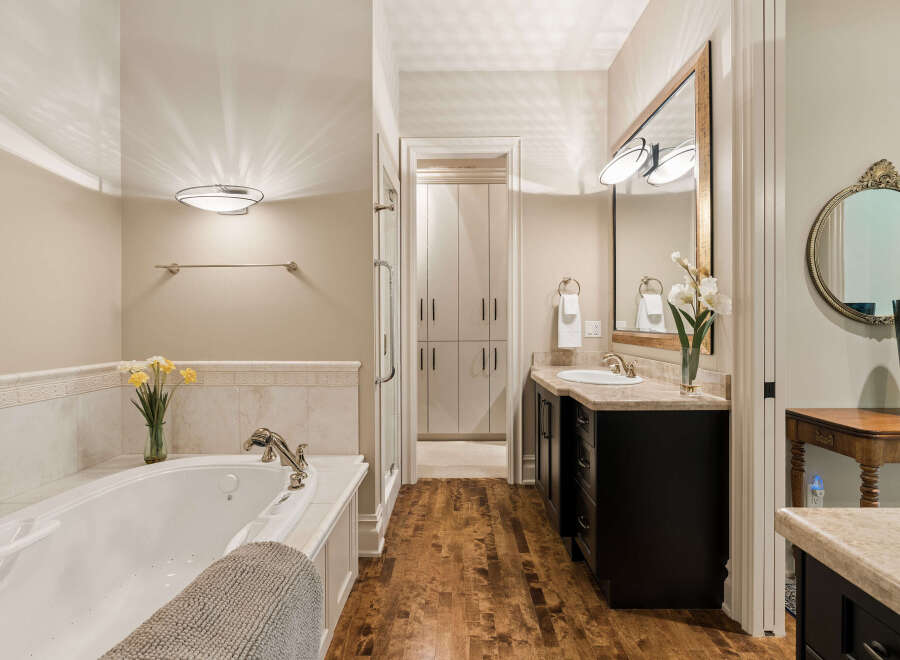 Indulge in luxury in this stunning bathroom featuring a spacious soaking tub perfect for relaxation.