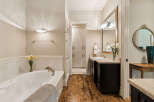 Indulge in luxury in this stunning bathroom featuring a spacious soaking tub perfect for relaxation.