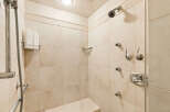 Experience ultimate relaxation in this luxurious shower featuring multiple shower heads for a spa-like experience.