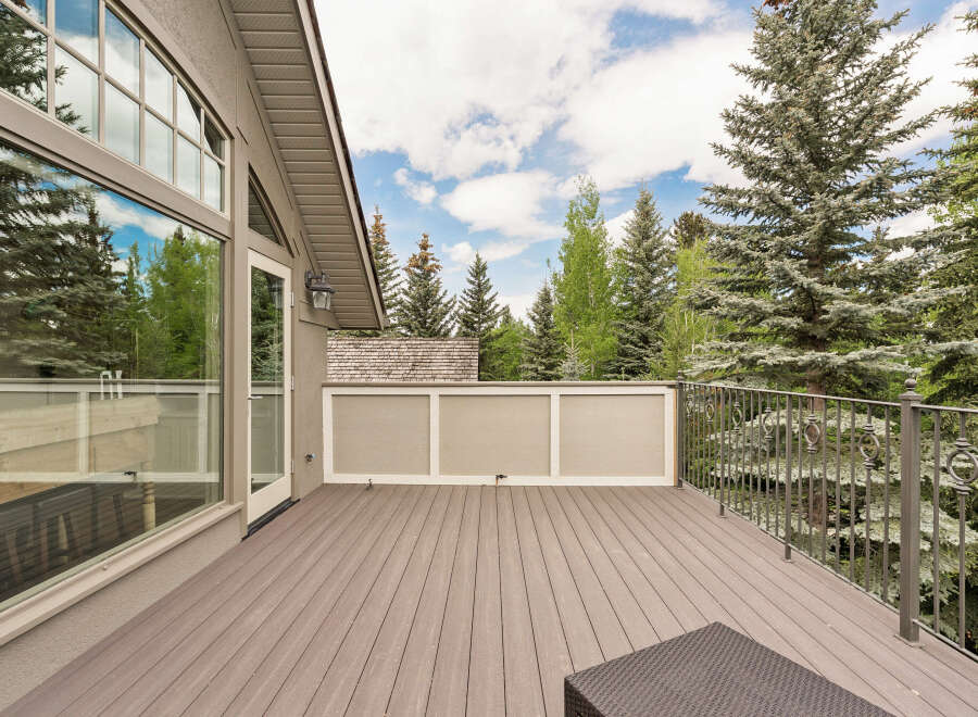 Enjoy the outdoors from this spacious deck, perfect for entertaining or relaxing amidst the serene forest backdrop.