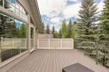 Enjoy the outdoors from this spacious deck, perfect for entertaining or relaxing amidst the serene forest backdrop.