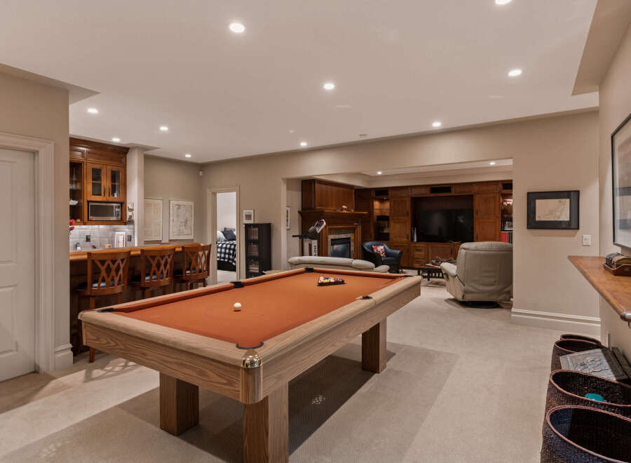 This finished basement offers a perfect blend of entertainment and relaxation.