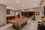 This finished basement offers a perfect blend of entertainment and relaxation.