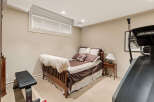 This versatile room features a comfortable bed with plush bedding, perfect for guests or a cozy retreat.