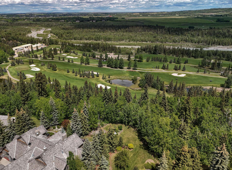 Experience luxury living with this stunning aerial view of a golf course estate.