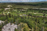 Experience luxury living with this stunning aerial view of a golf course estate.