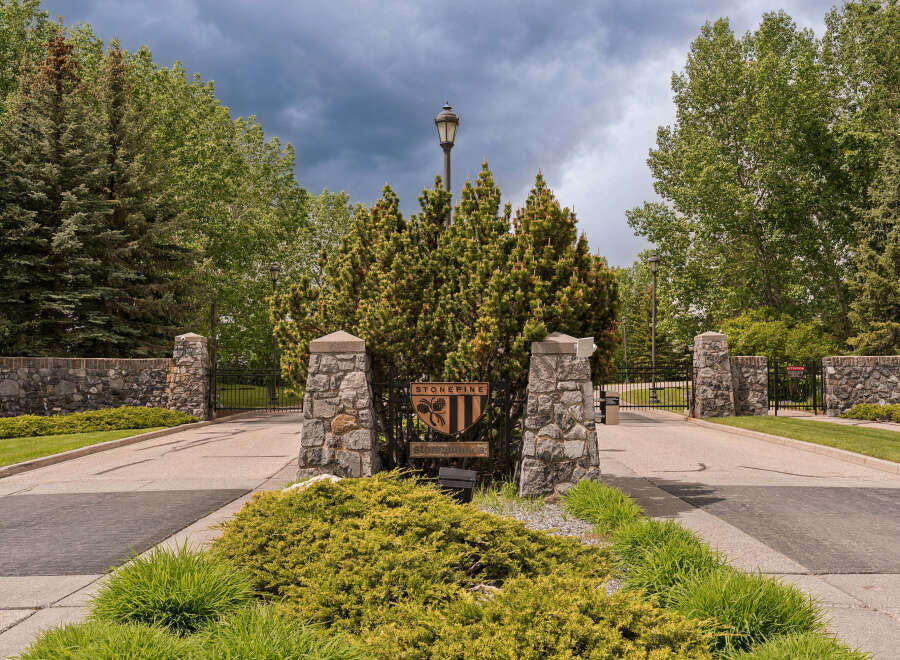 Discover the Stonepine community, a prestigious gated entrance with elegant stone pillars and lush landscaping.