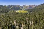 Nestled amidst a dense forest of mature pine trees, this property offers a serene mountain escape.