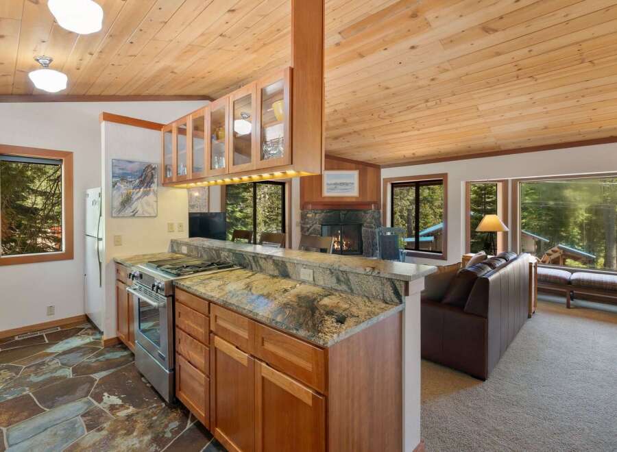 Experience cozy living in this charming mountain retreat, featuring a well-appointed kitchen with granite countertops and ample cabinet space.