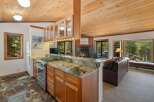 Experience cozy living in this charming mountain retreat, featuring a well-appointed kitchen with granite countertops and ample cabinet space.
