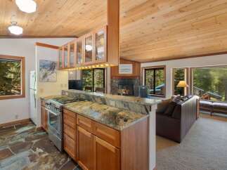 Experience cozy living in this charming mountain retreat, featuring a well-appointed kitchen with granite countertops and ample cabinet space.