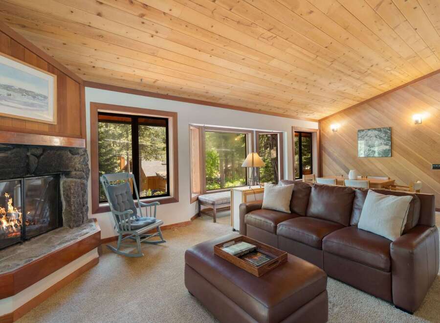 Cozy living room featuring a stone fireplace and a comfortable leather sofa, perfect for relaxing evenings.