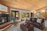 Cozy living room featuring a stone fireplace and a comfortable leather sofa, perfect for relaxing evenings.