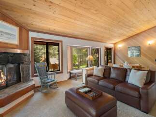 Cozy living room featuring a stone fireplace and a comfortable leather sofa, perfect for relaxing evenings.