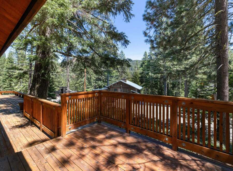 Enjoy the serene mountain views from this expansive wooden deck, perfect for outdoor entertaining or quiet relaxation.