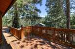 Enjoy the serene mountain views from this expansive wooden deck, perfect for outdoor entertaining or quiet relaxation.