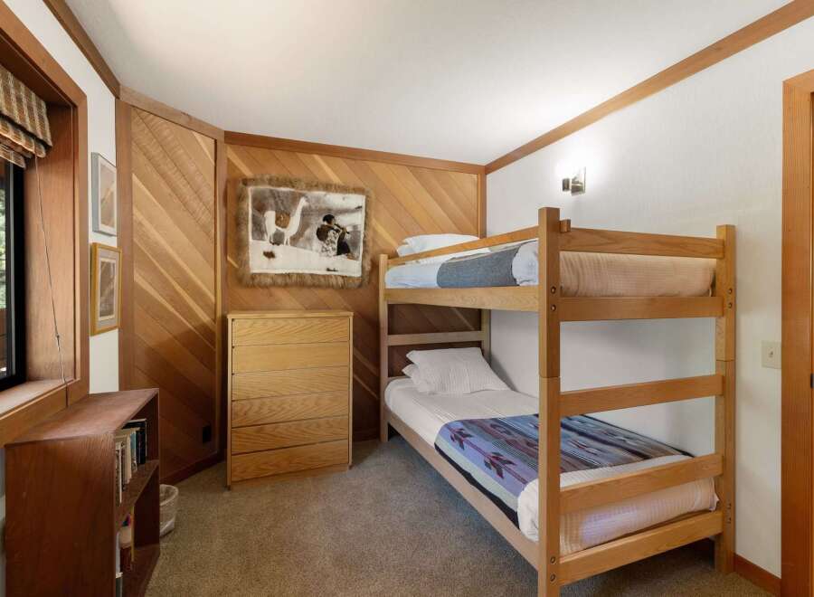 This charming bedroom features a cozy bunk bed, perfect for accommodating guests or children.