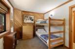This charming bedroom features a cozy bunk bed, perfect for accommodating guests or children.