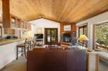 Experience cozy living in this charming mountain retreat, featuring a stunning stone fireplace as the centerpiece of the living area.