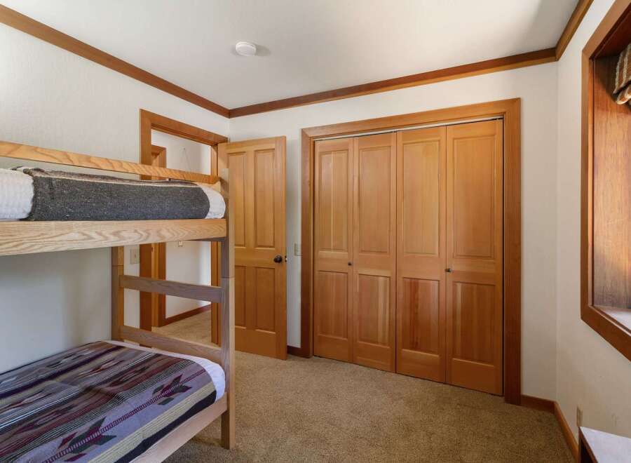 This charming bedroom features a space-saving bunk bed, perfect for accommodating guests or family.