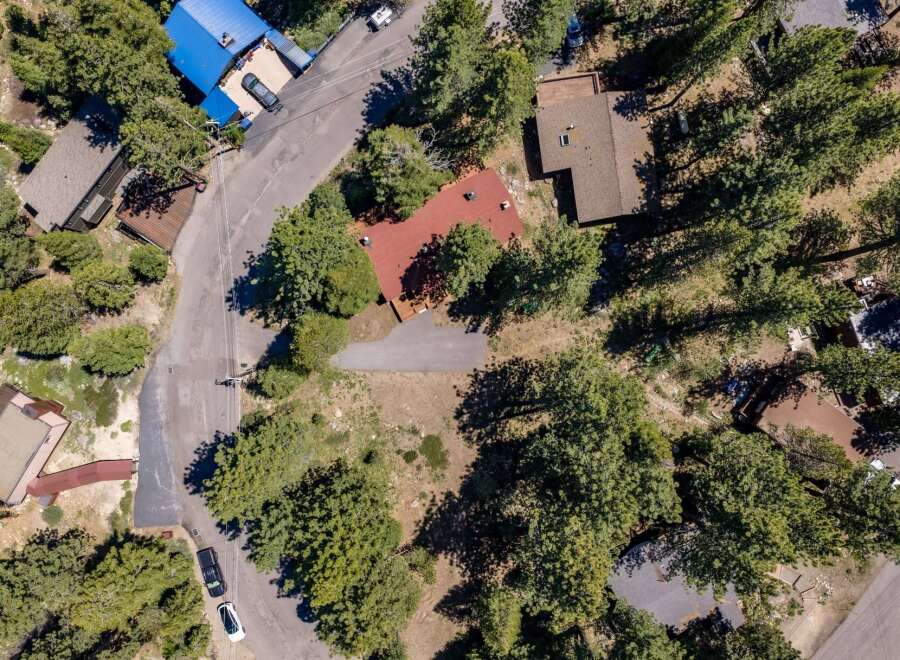 Discover this charming property nestled amongst mature pine trees, offering a serene and private mountain retreat.