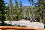 Experience mountain living with this unique property featuring a spacious wooden deck perfect for outdoor entertaining and enjoying the surrounding forest views.